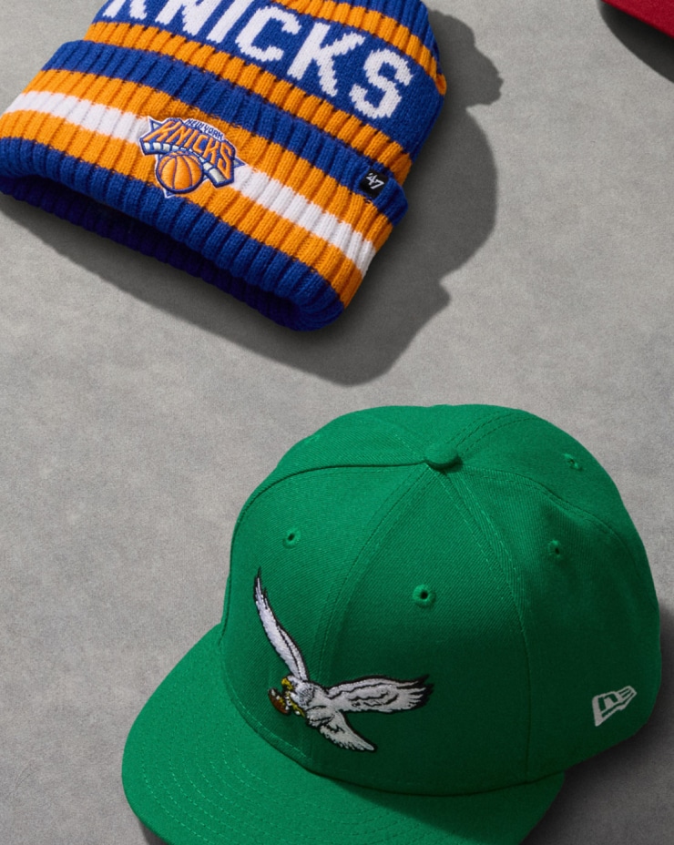 New York Knicks beanie and Philadelphia Eagles cap