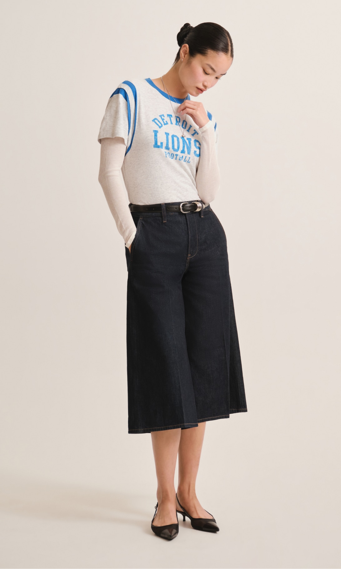 Woman in a Detroit Lions tee with wide-leg denim