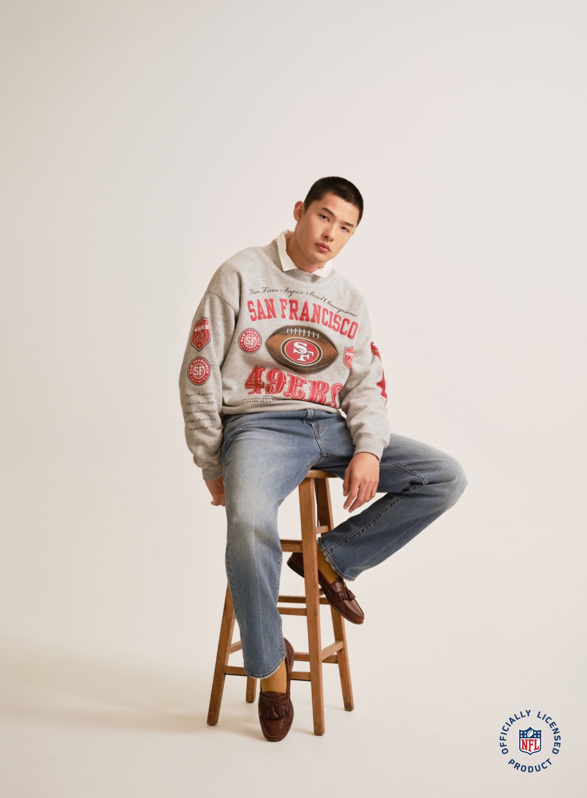 Man wearing a San Francisco 49ers graphic sweatshirt with jeans